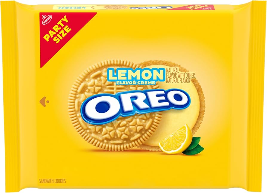A yellow Party Size OREO package labeled 'Lemon Flavor Creme,' with a golden sandwich cookie split to show pale yellow filling, a lemon wedge and green leaves, and the blue OREO logo.