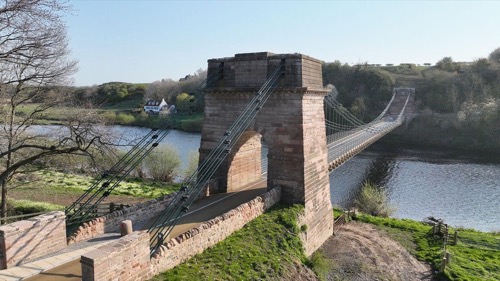 The Union Chain Bridge: a chain-link suspension bridge with a stone tower, spanning the River Tweed between England and Scotland.