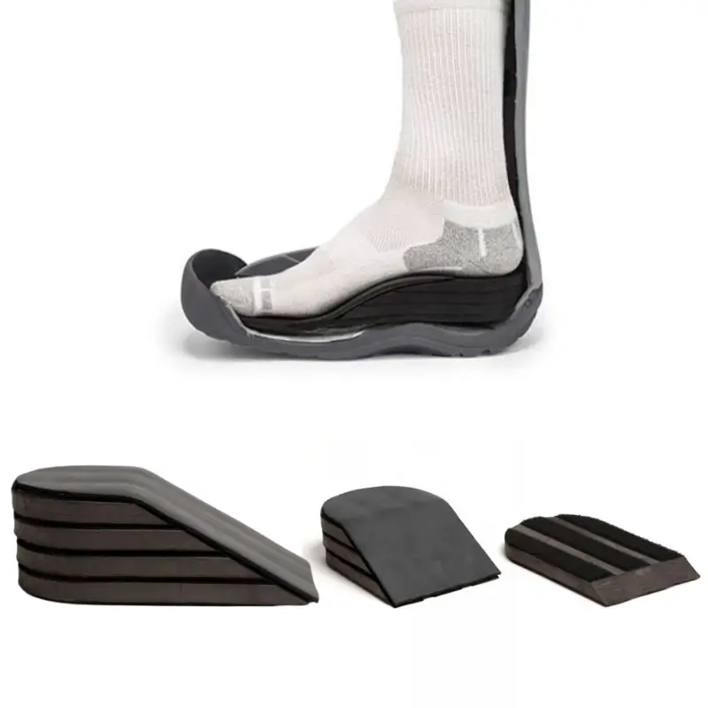 A product photo of stacked heel-lift wedges: a socked foot resting inside a walker boot liner on a tall stack of dark foam wedge layers, with three loose wedge stacks of decreasing height lined up below it, each made of thin peel-away slices.