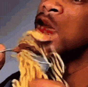 The Will Smith 'eating spaghetti' meme: a man enthusiastically shoveling a forkful of noodles into his mouth.